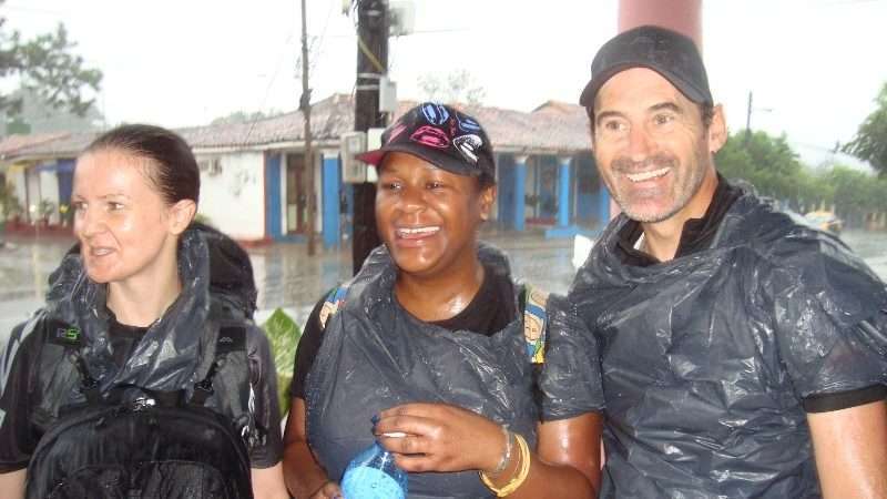 Three travellers wearing garbage bags in the rain