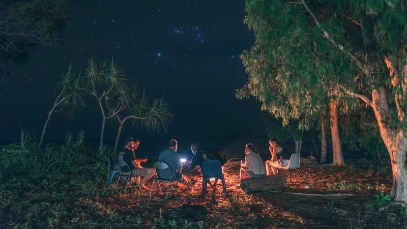 Groups sits under the stars in Arnhem Land, Australia