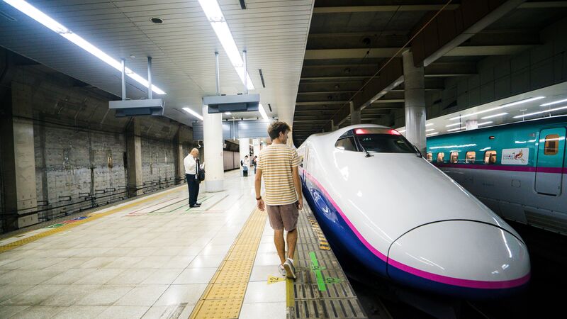 A man getting onto a bullet train in Tokyo